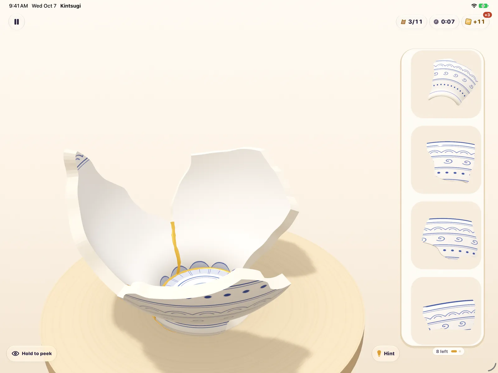 Kintsugi on iPad in landscape: a broken bowl on the left and a column of shards on the right.